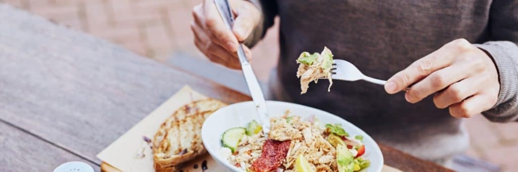 man eating a salad for lunch